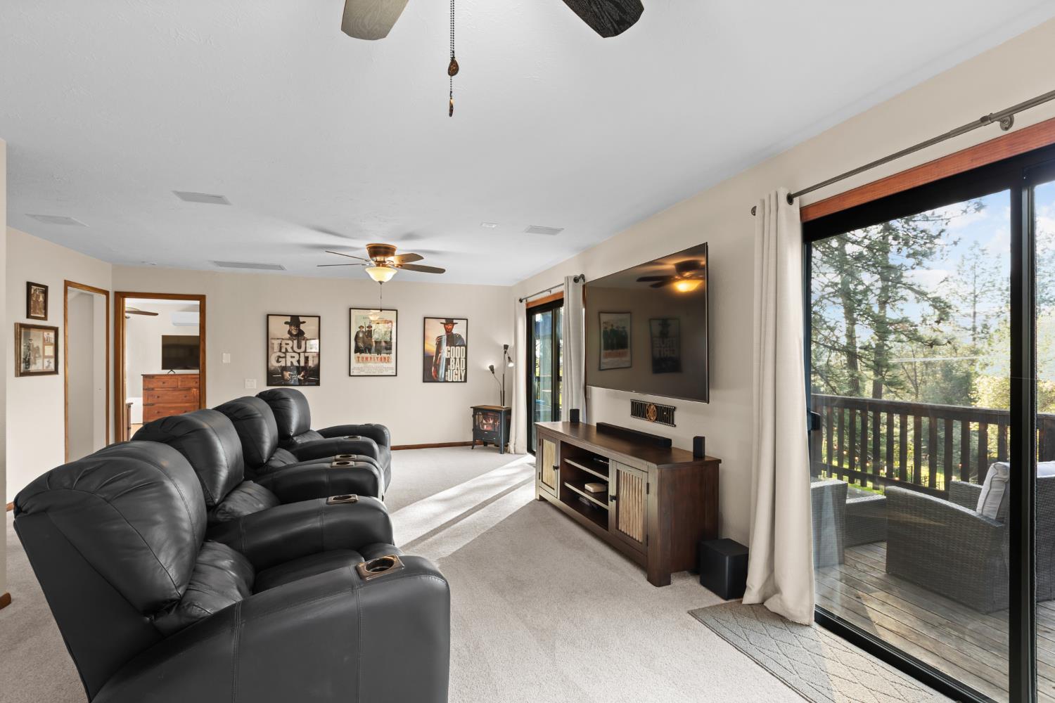 17476 Fiddletown Road Fiddletown, CA 95629 - Photo 26 of 82 a living room with furniture a flat screen tv and a floor to ceiling window