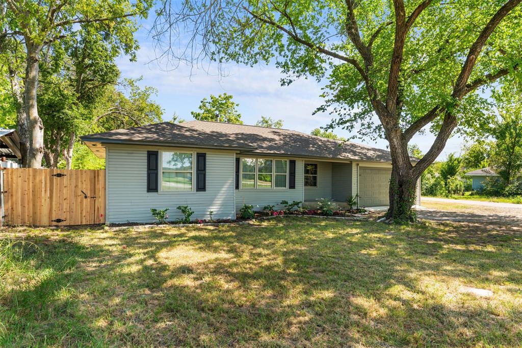 612 East 8th Street Kemp, TX 75143 - Photo 22 of 27 a view of a house with a yard