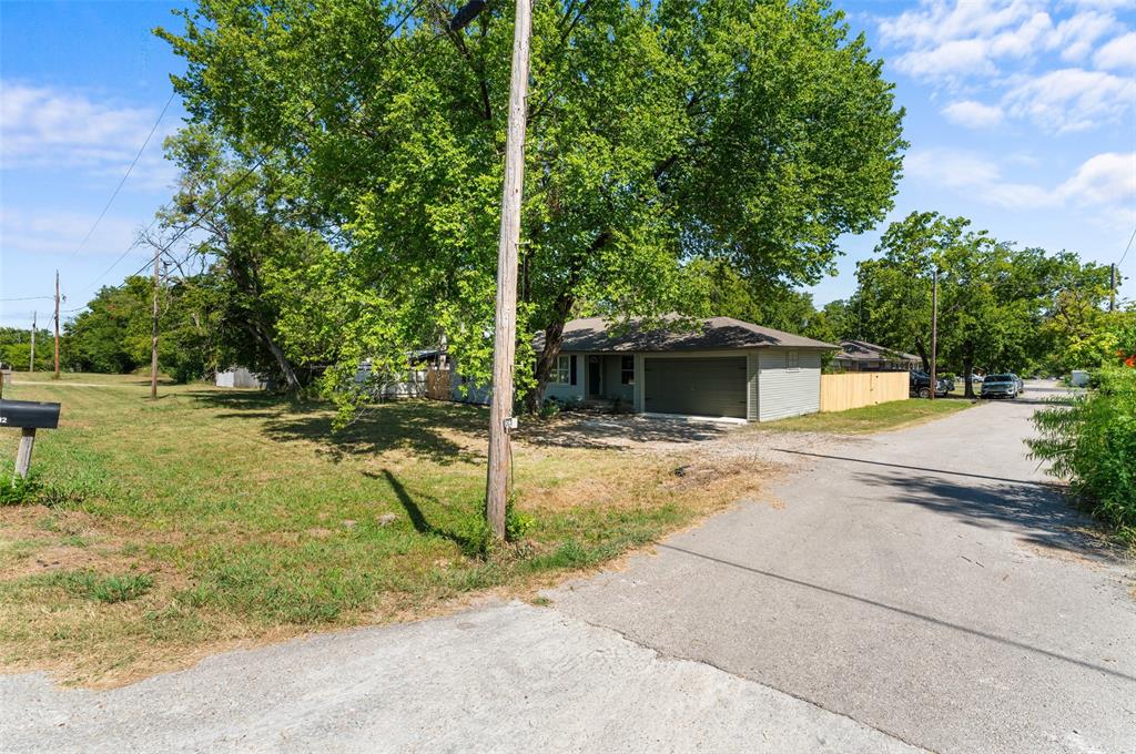 612 East 8th Street Kemp, TX 75143 - Photo 23 of 27 a view of a yard with plants and trees