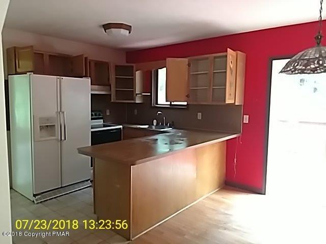 263 Canterbury Road Bushkill, PA 18324 - Photo 4 of 16 a kitchen with stainless steel appliances granite countertop a refrigerator and a sink