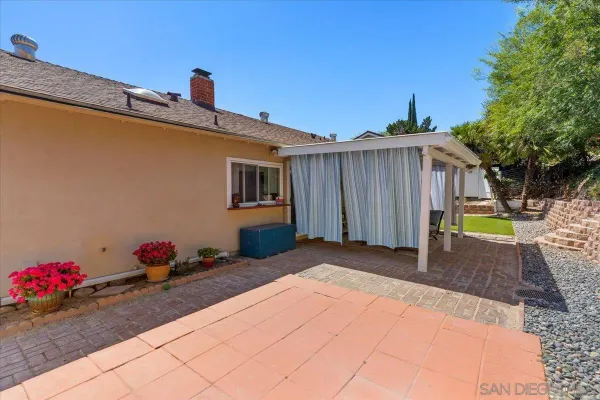 a view of a patio with a table and chairs