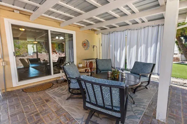 a view of a patio with furniture and a yard
