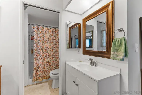 a bathroom with a shower curtain and a sink