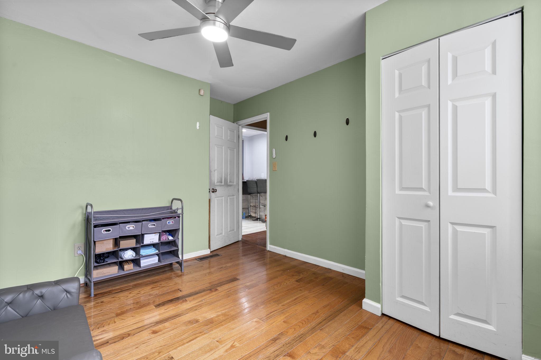 1232 Savannah Place Southeast Washington, DC 20032 - Photo 13 of 29 an empty room with wooden floor closet and windows