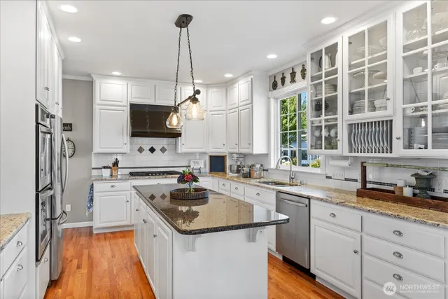 a kitchen with a sink a stove a refrigerator and cabinets