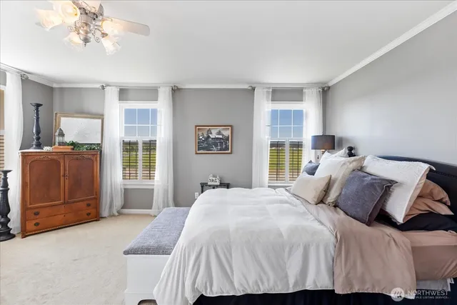 a bedroom with a large bed and a chandelier