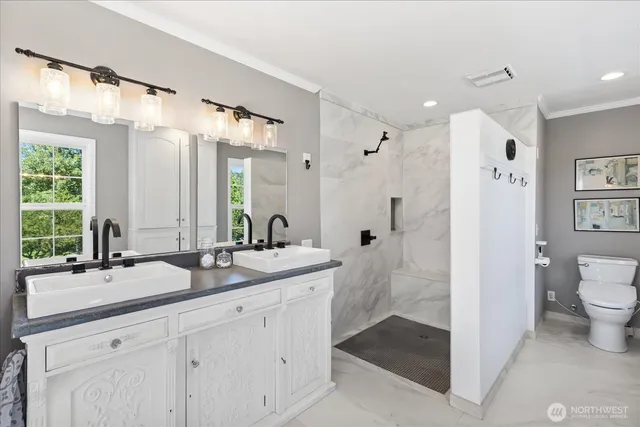 a bathroom with a double vanity sink mirror double and shower