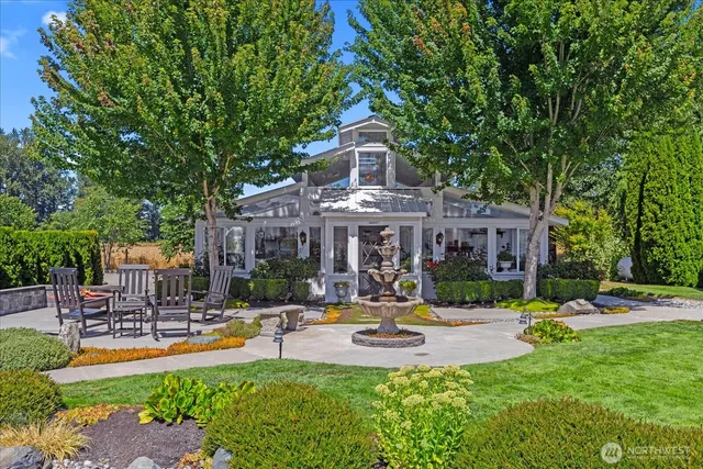 a swimming pool with outdoor seating and yard