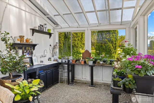 a view of a porch with chairs potted plants