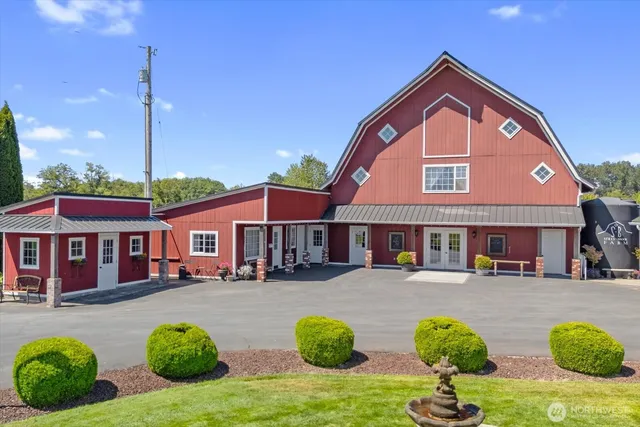 a front view of a house with garden and plants