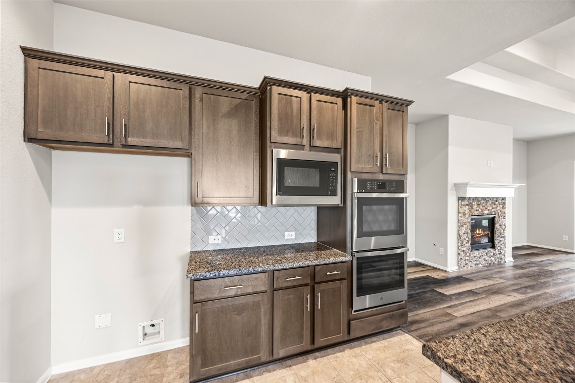 11202 Seguin Trail Needville, TX 77461 - Photo 11 of 31 a kitchen with stainless steel appliances granite countertop a refrigerator and a stove top oven