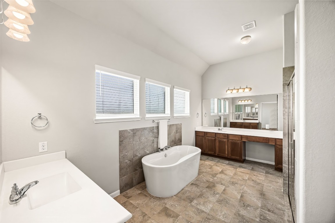 11202 Seguin Trail Needville, TX 77461 - Photo 15 of 31 a bathroom with a tub sink and mirror