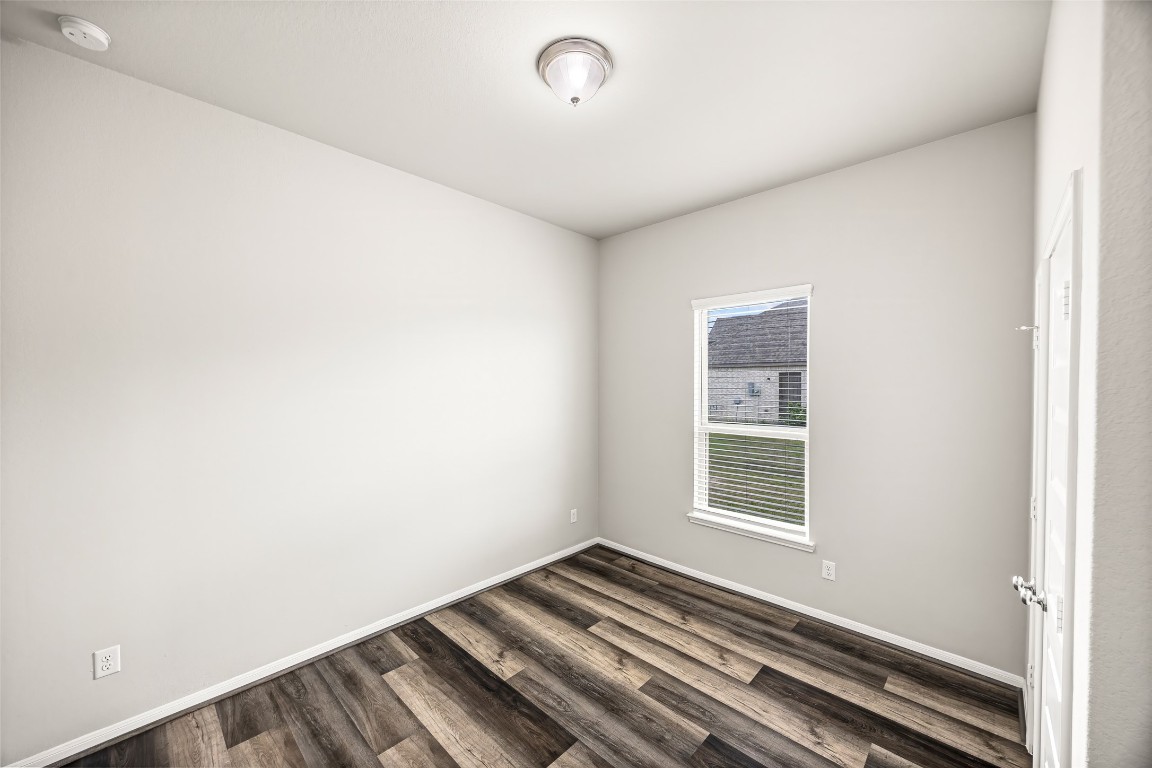 11202 Seguin Trail Needville, TX 77461 - Photo 19 of 31 a view of a room with wooden floor and windows