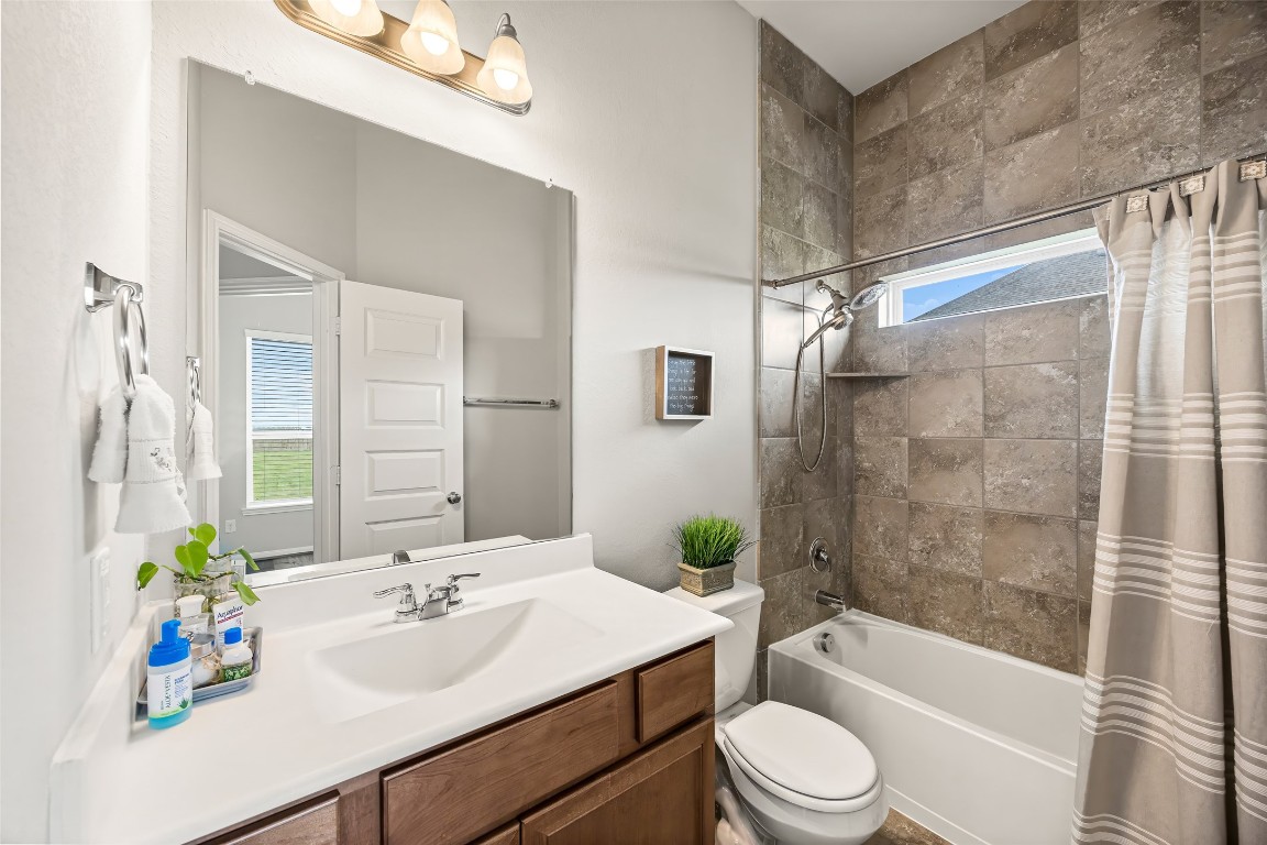 11202 Seguin Trail Needville, TX 77461 - Photo 20 of 31 a bathroom with a sink a toilet a bathtub and shower