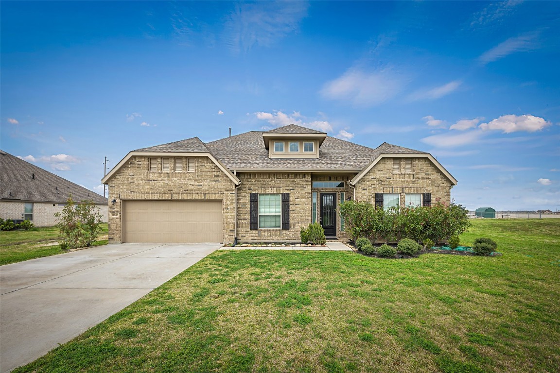 11202 Seguin Trail Needville, TX 77461 - Photo 2 of 31 a front view of a house with garden
