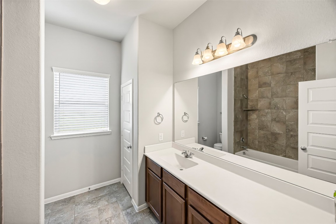 11202 Seguin Trail Needville, TX 77461 - Photo 22 of 31 a bathroom with a double vanity sink mirror and shower