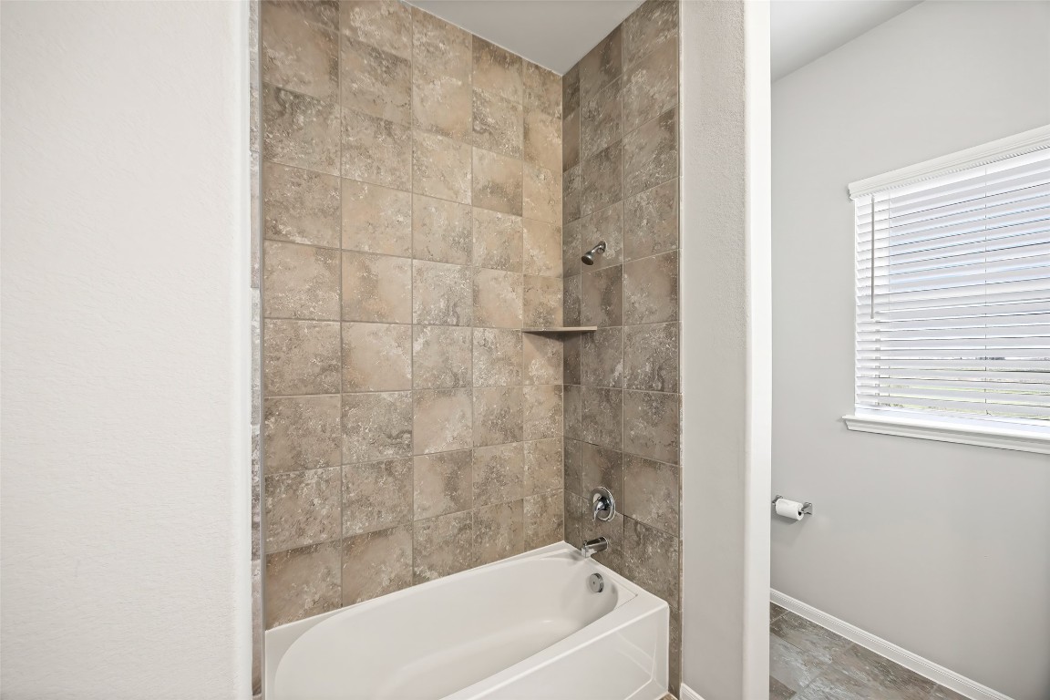 11202 Seguin Trail Needville, TX 77461 - Photo 23 of 31 a bathroom with a bathtub and shower