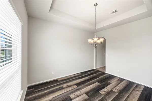 a room with a chandelier and a window