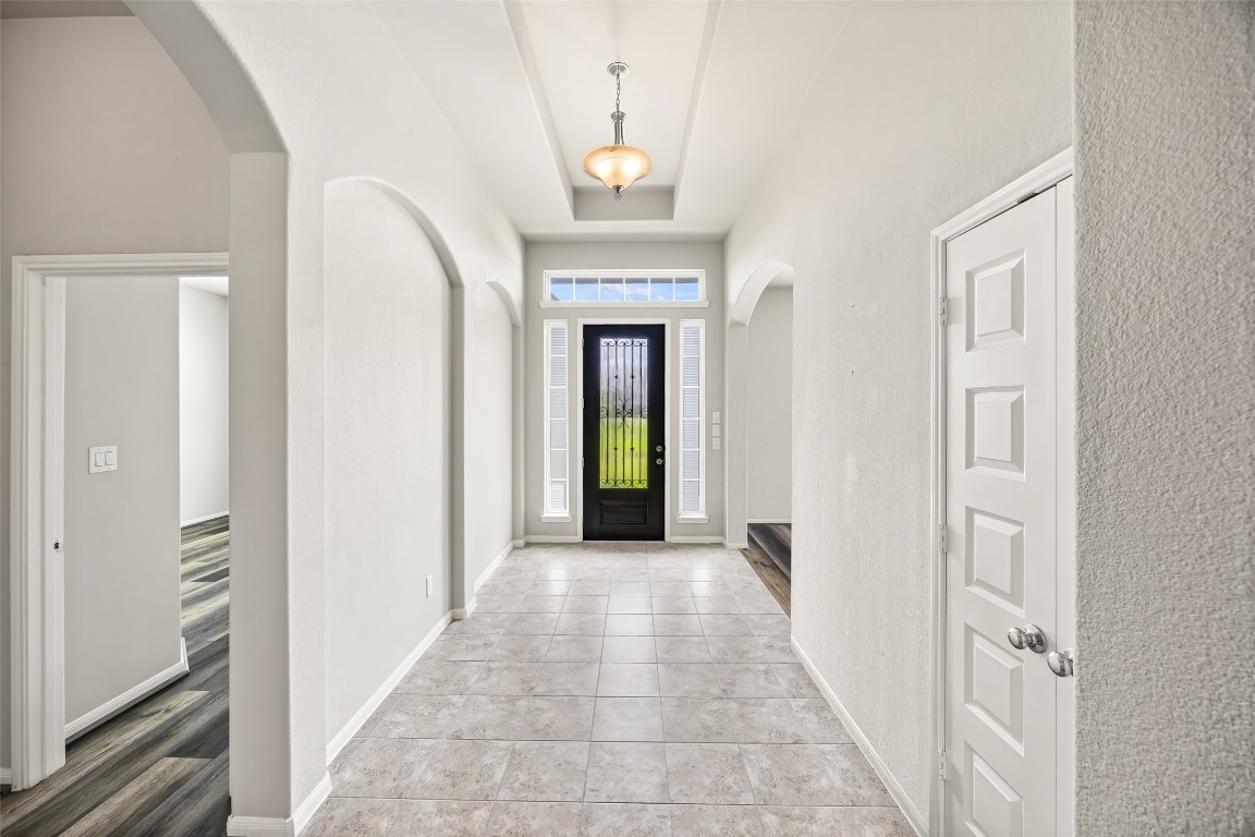11202 Seguin Trail Needville, TX 77461 - Photo 5 of 31 a view of a hallway with a chandelier