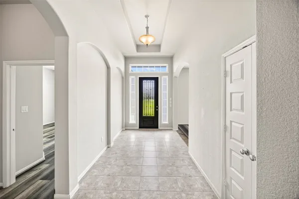 a view of a hallway with a chandelier
