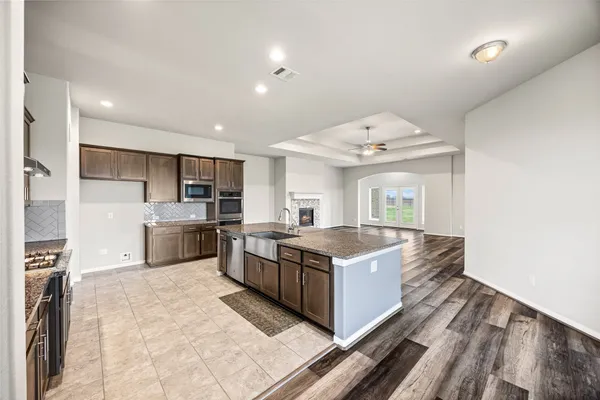 a kitchen with stainless steel appliances granite countertop a stove and a sink