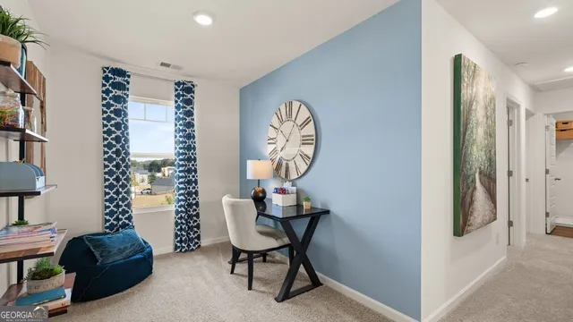 a view of a workspace with furniture and a window