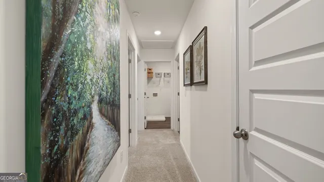 a view of a hallway with closet and wooden floor