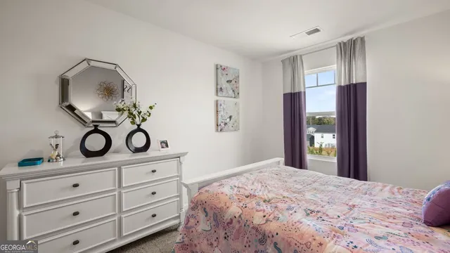 a bedroom with a bed and cabinets