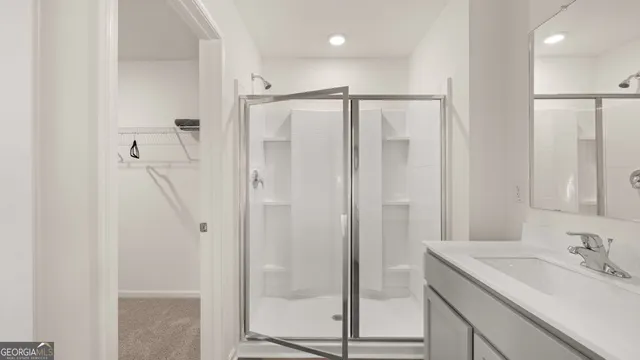 a bathroom with a shower sink and mirror