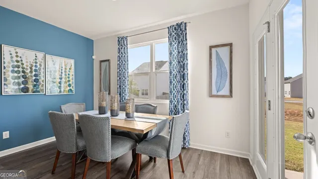 a view of a dining room with furniture window and wooden floor