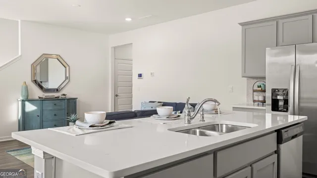 a kitchen with a sink a stove and a refrigerator