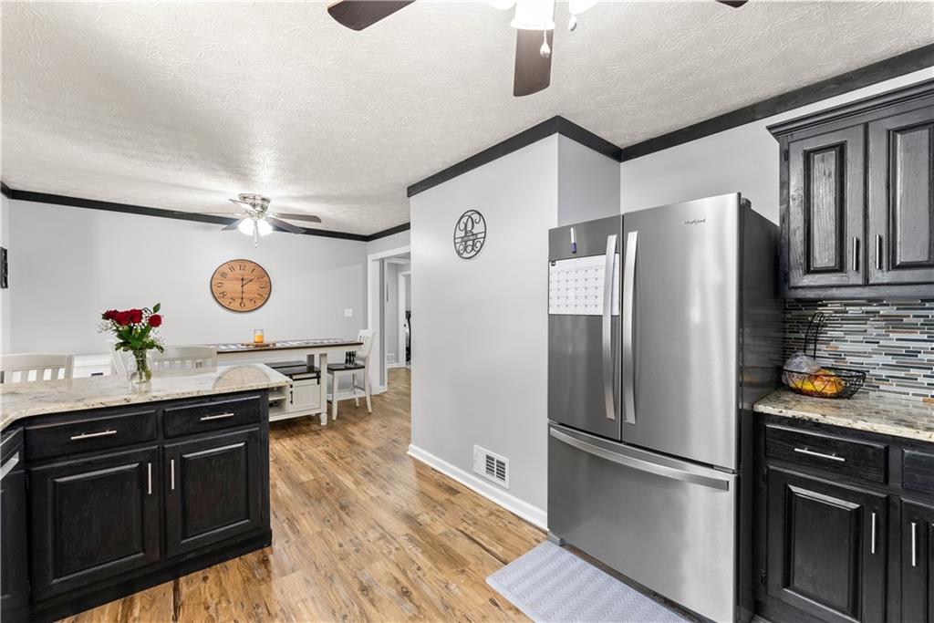 1405 Tapp Wood Road Hoschton, GA 30548 - Photo 14 of 44 a kitchen with stainless steel appliances granite countertop a refrigerator a stove and a sink with dishwasher