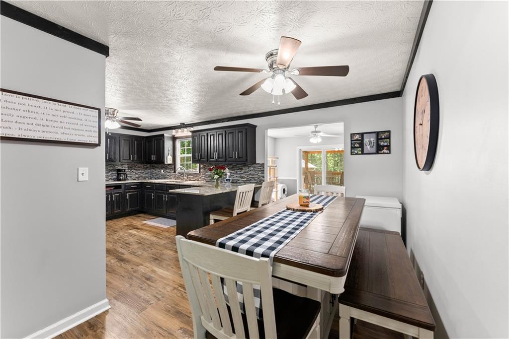 1405 Tapp Wood Road Hoschton, GA 30548 - Photo 15 of 44 a kitchen with a table chairs microwave and cabinets