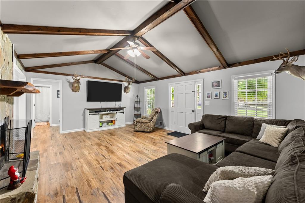 1405 Tapp Wood Road Hoschton, GA 30548 - Photo 20 of 44 a living room with furniture and a flat screen tv
