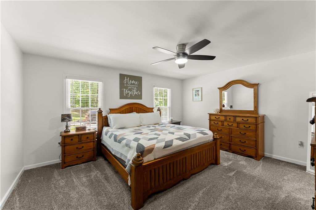 1405 Tapp Wood Road Hoschton, GA 30548 - Photo 21 of 44 a bedroom with a bed chandelier and a window