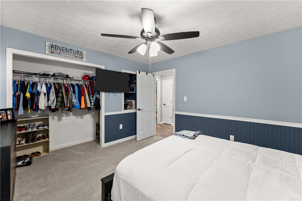 1405 Tapp Wood Road Hoschton, GA 30548 - Photo 28 of 44 a bedroom with a bed and a walk in closet