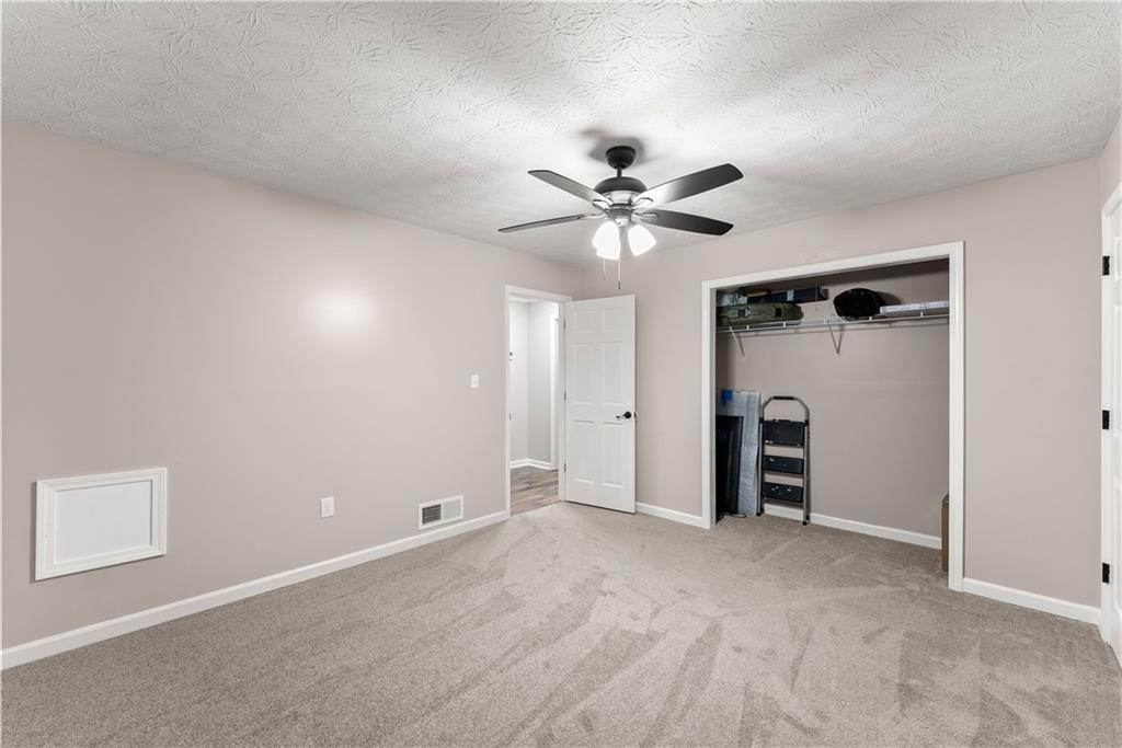 1405 Tapp Wood Road Hoschton, GA 30548 - Photo 30 of 44 a view of an empty room with a ceiling fan