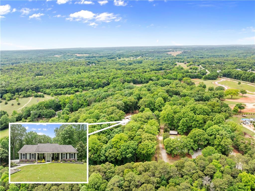 1405 Tapp Wood Road Hoschton, GA 30548 - Photo 3 of 44 a view of a city with a houses