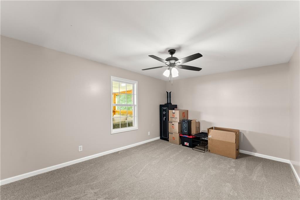 1405 Tapp Wood Road Hoschton, GA 30548 - Photo 33 of 44 a living room with a ceiling fan and a window
