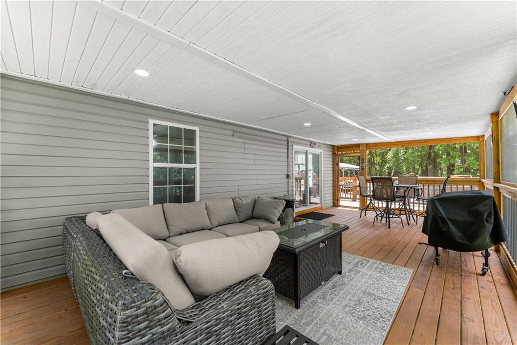 1405 Tapp Wood Road Hoschton, GA 30548 - Photo 36 of 44 a living room with furniture and a wooden floor