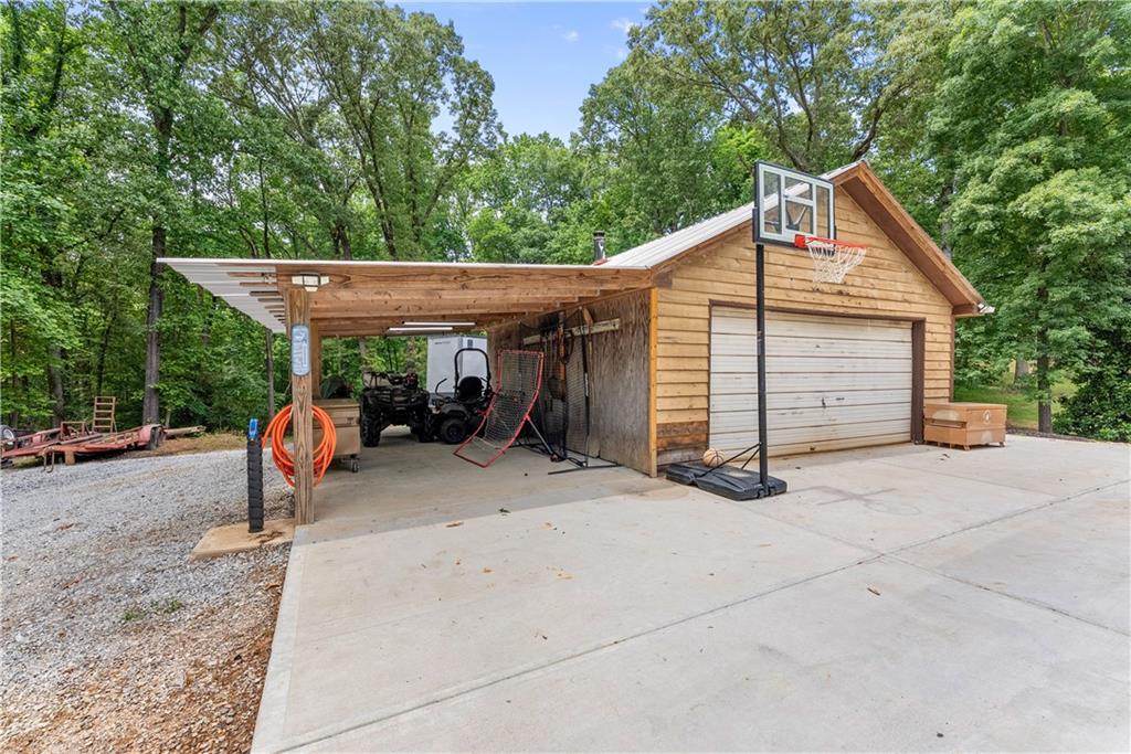1405 Tapp Wood Road Hoschton, GA 30548 - Photo 39 of 44 a view of a wooden house with large trees and wooden fence