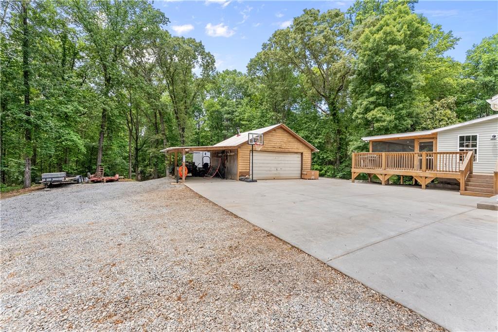 1405 Tapp Wood Road Hoschton, GA 30548 - Photo 40 of 44 a front view of a house with a yard and garage