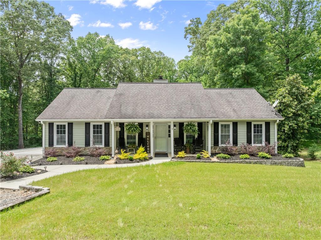 1405 Tapp Wood Road Hoschton, GA 30548 - Photo 4 of 44 a front view of a house with yard and green space