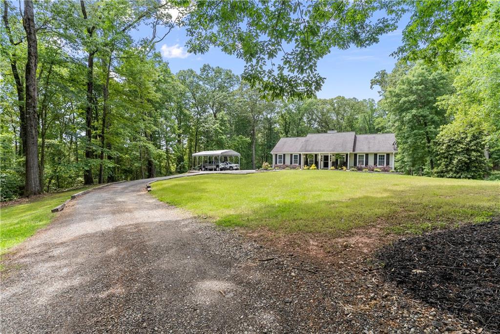 1405 Tapp Wood Road Hoschton, GA 30548 - Photo 6 of 44 a view of a house with swimming pool and yard