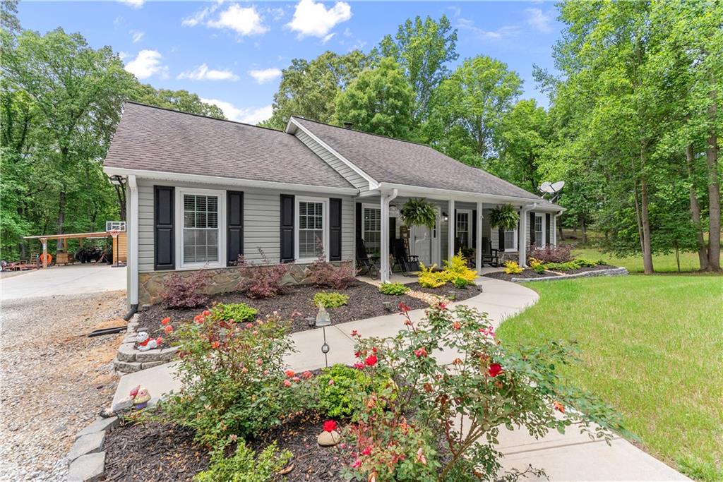 1405 Tapp Wood Road Hoschton, GA 30548 - Photo 8 of 44 a view of a house with sitting area and garden