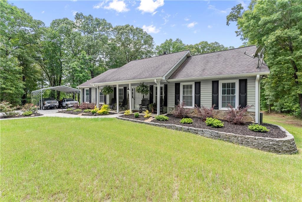 1405 Tapp Wood Road Hoschton, GA 30548 - Photo 9 of 44 a front view of house with yard and outdoor seating