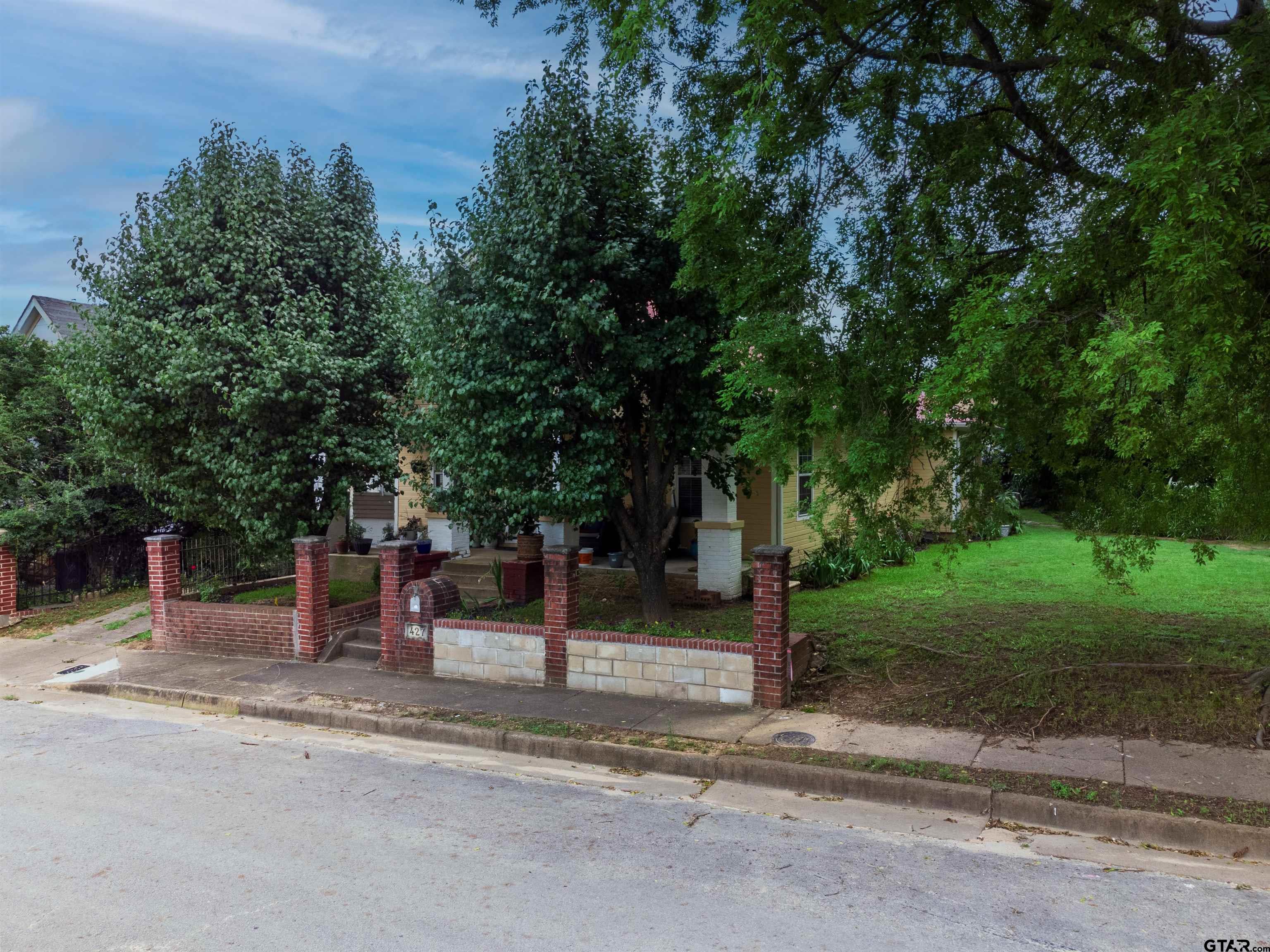 427 East Locust Street Tyler, TX 75702 - Photo 40 of 42 a street view with tall trees