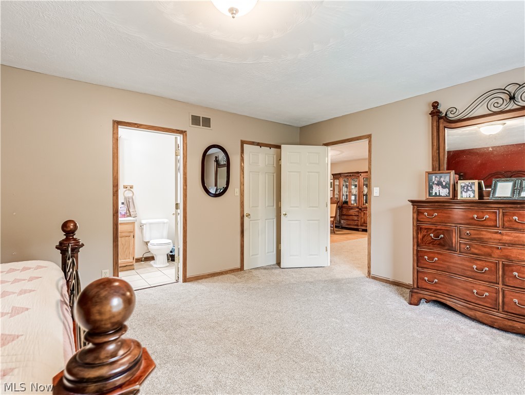 2700 Old Forge Road Kent, OH 44240 - Photo 16 of 34 Bedroom with light carpet and ensuite bath