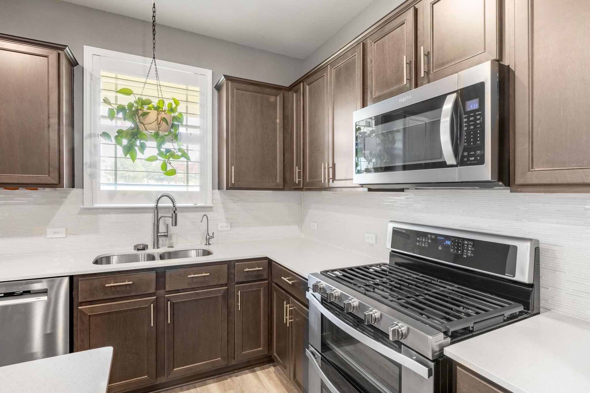 7801 Frida Bend Austin, TX 78744 - Photo 4 of 26 Modern kitchen features sleek cabinetry and pristine countertops, perfect for culinary endeavors.