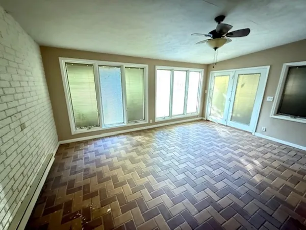 a view of a room with furniture and a window